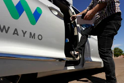 A Waymo minivan arrives to pick up passengers in Mesa, Ariz., April 7, 2021.