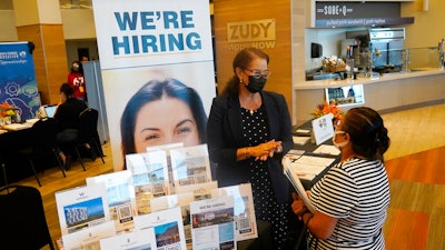 Marriott human resources recruiter Mariela Cuevas, left, talks to Lisbet Oliveros, during a job fair at Hard Rock Stadium, Friday, Sept. 3, 2021, in Miami Gardens, Fla. Fewer Americans applied for unemployment benefits last week, as layoffs continue to decline amid a strong job market rebound. Jobless claims fell by 15,000 to 214,000 for the week ending March 12, 2022 down from the previous week's 229,000, the Labor Department reported Thursday, March 17.
