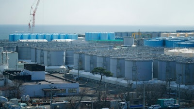 Tanks storing treated radioactive water after it was used to cool the melted fuel are seen at the Fukushima Daiichi nuclear power plant, run by Tokyo Electric Power Company Holdings (TEPCO), in Okuma town, northeastern Japan, Thursday, March 3, 2022. The government has announced plans to release the water after treatment and dilution to well below the legally releasable levels through a planned undersea tunnel at a site about 1 kilometer offshore.