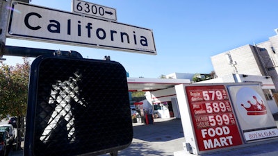 A California street sign is shown next to the price board at a gas station in San Francisco, on March 7, 2022. The average U.S. price of regular-grade gasoline shot up a whopping 79 cents over the past two weeks to $4.43 per gallon. Industry analyst Trilby Lundberg of the Lundberg Survey says Sunday, March 13, the new price exceeds by 32 cents the prior record high of $4.11 set in July 2008. Lundberg said gas prices are likely to remain high in the short term as crude oil costs soar amid global supply concerns following Russia's invasion of Ukraine. Nationwide, the highest average price for regular-grade is in the San Francisco Bay Area, at $5.79.