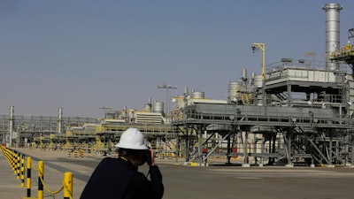 A photographer takes pictures of the Khurais oil field during a tour for journalists, 150 km east-northeast of Riyadh, Saudi Arabia, June 28, 2021. In a statement on Monday, March 21, 2022, carried by the state-run Saudi Press Agency, Saudi Arabia said it “won’t bear any responsibility for any shortage in oil supplies to global markets” after attacks by Yemen’s Iran-backed Houthi rebels have affected the kingdom’s production.