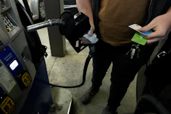 A customer prepares to pump gasoline into his car at a Sam's Club in Gulfport, Miss., Feb. 19, 2022.