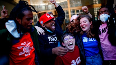 Staten Island-based Amazon.com Inc distribution center union members celebrate after getting the voting results to unionize on Friday, April 1, 2022, in New York. Amazon workers in Staten Island voted to unionize, marking the first successful U.S. organizing effort in the retail giant's history and handing an unexpected win to a nascent group that fueled the union drive.