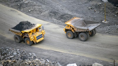 A loaded dump truck passes an empty truck as it carries away coal at the Kedrovsky open-pit coal mine in Kemerovo, Russia, Tuesday, June 16, 2015. Poland’s government has decided to block imports of coal from Russia. The move is an element in a larger strategy to reduce energy dependence on Russia which gained new urgency after the invasion of Ukraine. The government of Prime Minister Mateusz Morawiecki agreed to impose financial penalties on the private entities importing Russian coal into Poland, with Polish customs officials tasked with carrying out checks.