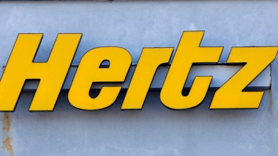 In this Nov. 28, 2017 photo a Hertz rental car logo rests on the front of a Hertz location, in Boston. Hertz is planning to buy up to 65,000 electric vehicles from Swedish premium electric car maker Polestar over the next five years as it looks to boost its electric vehicle rental fleet. Financial terms were not disclosed. The vehicles are expected to be available in Europe in the spring and in North America and Australia later this year. The announcement on Monday, April 4, 2022 comes more than five months after Hertz said that it will buy 100,000 electric vehicles from Tesla.