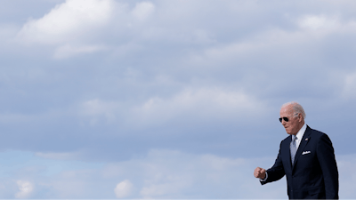 President Joe Biden walks to a motorcade vehicle after stepping off Air Force One, Tuesday, April 19, 2022, at Andrews Air Force Base, Md. Biden is returning to Washington after promoting his infrastructure agenda in New Hampshire.