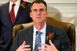 Oklahoma Gov. Kevin Stitt speaks at a signing ceremony to sign into law a bill, Tuesday, April 12, 2022, in Oklahoma City. The governor is asking lawmakers to approve a massive package of financial incentives to help lure an unnamed company to the state. Stitt made the request at a news conference on Monday, April 18. He told reporters he was prohibited from naming the company or the total cost of the package.