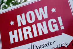 A 'now hiring' sign is posted in Garnet Valley, Pa., Monday, May 10, 2021. Applications for unemployment benefits inched down last week, Thursday, April 21, 2022, as the total number of Americans collecting aid fell to its lowest level in more than 50 years.