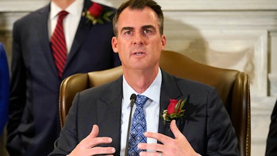 Oklahoma Gov. Kevin Stitt speaks at a signing ceremony to sign into law a bill, Tuesday, April 12, 2022, in Oklahoma City. The governor is asking lawmakers to approve a massive package of financial incentives to help lure an unnamed company to the state. Stitt made the request at a news conference on Monday, April 18. He told reporters he was prohibited from naming the company or the total cost of the package.