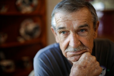 In this Aug. 7, 2019, photo, Doug Bledsoe sits in his home in Powell, Tenn. Bledsoe was called to work at Kingston Fossil Plant just days after the 2008 collapse of a six-story earthen dam released more than a billion gallons of coal ash sludge. Bledsoe drove a water truck there until 2014. In 2018, he was diagnosed with lung and brain cancer. He died two years later, leaving behind his wife of 38 years, Johnnie Bledsoe.