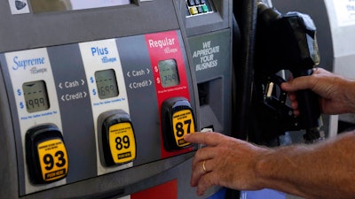 A customer pumps gas at an Exxon gas station, May 10, 2022, Miami.
