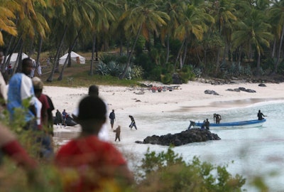 Rescuers gather at Galawa Beach, 35 kilometers from Moroni, Comoros, July 1, 2009, as they prepare to search the area after a Yemenia Airbus passenger plane crashed into the Indian Ocean off the island nation of Comoros, early Tuesday, as it attempted to land in the dark amid howling winds. The lone survivor of a 2009 plane crash that killed 152 other people is expected to attend the trial of Yemen's main airline which is opening Monday May 9, 2022 in Paris.