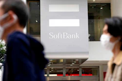 Passersby move past a SoftBank shop in Tokyo, Thursday, May 12, 2022. Japanese technology company SoftBank Group reported Thursday it has dropped into losses as the value of its investments declined.