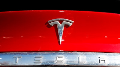 The Tesla company logo sits on a vehicle at a Tesla dealership in Littleton, Colo., on Feb. 2, 2020. The U.S. government’s road safety agency has dispatched a team to investigate the possibility that a Tesla involved in a California crash that killed three people was operating on a partially automated driving system. The National Highway Traffic Safety Administration on Wednesday, May 18, 2022 confirmed that it had sent a special crash investigation team to probe the May 12 crash on the Pacific Coast Highway in Newport Beach.
