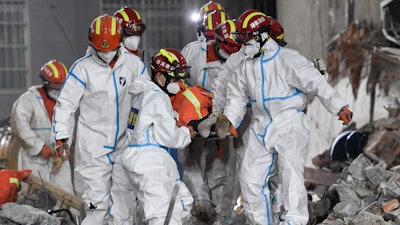 Rescuers in central China have pulled the woman alive from the rubble of a building that partially collapsed almost six days earlier, state media reported Thursday.