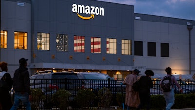 People arrive for work at the Amazon distribution center, Staten Island, New York, Oct. 25, 2021.