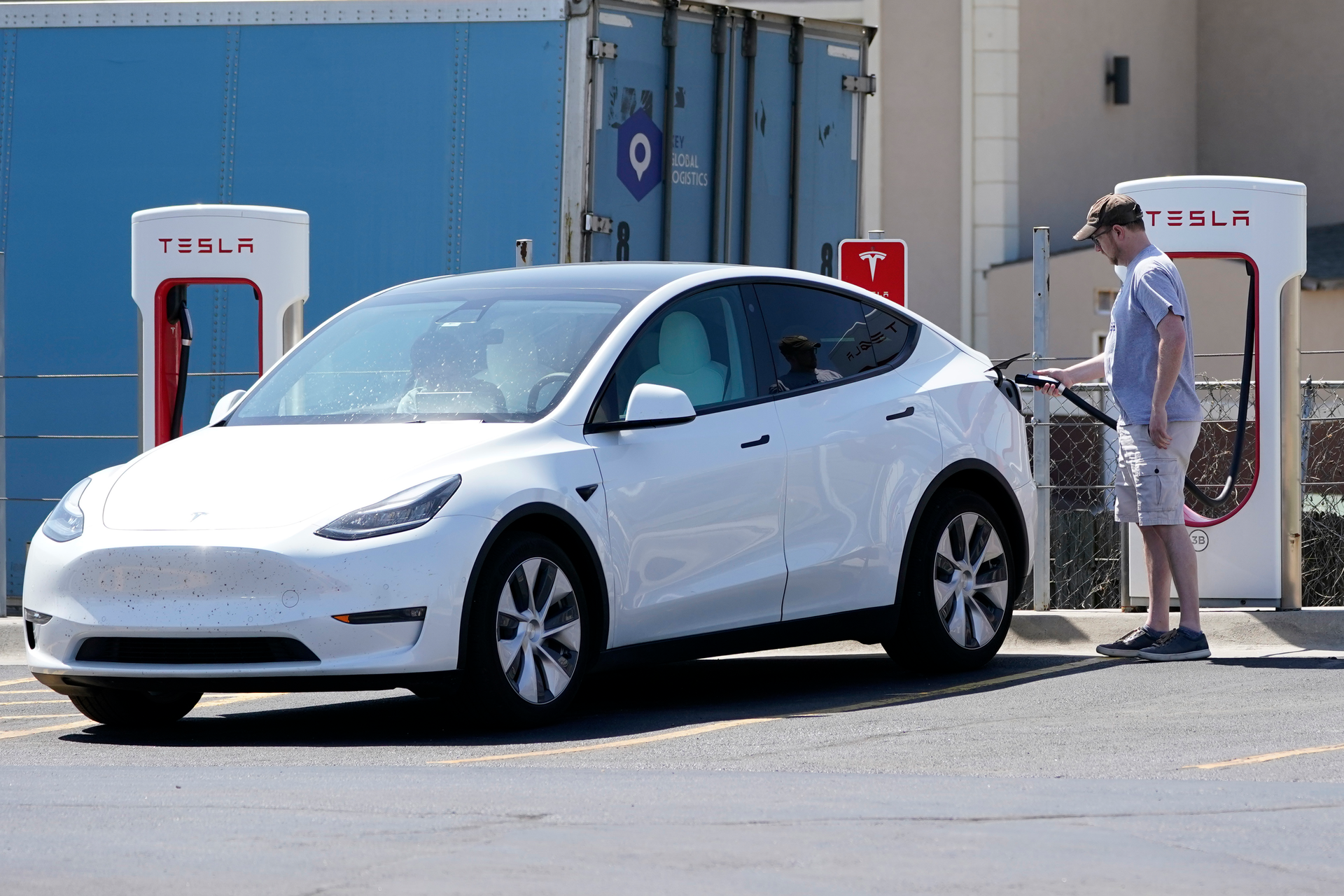A Tesla owner charges his vehicle at a charging station in Topeka, Kan., Monday, April 5, 2021.