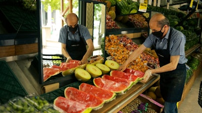 A worker arranges fruit for sale a food market in Ankara, Turkey, Friday, June 3, 2022. Annual inflation in Turkey hit 73.5% in May, according to official data released by the Turkish Statistical Institute on Friday, as a cost-of-living crisis in the country deepens.