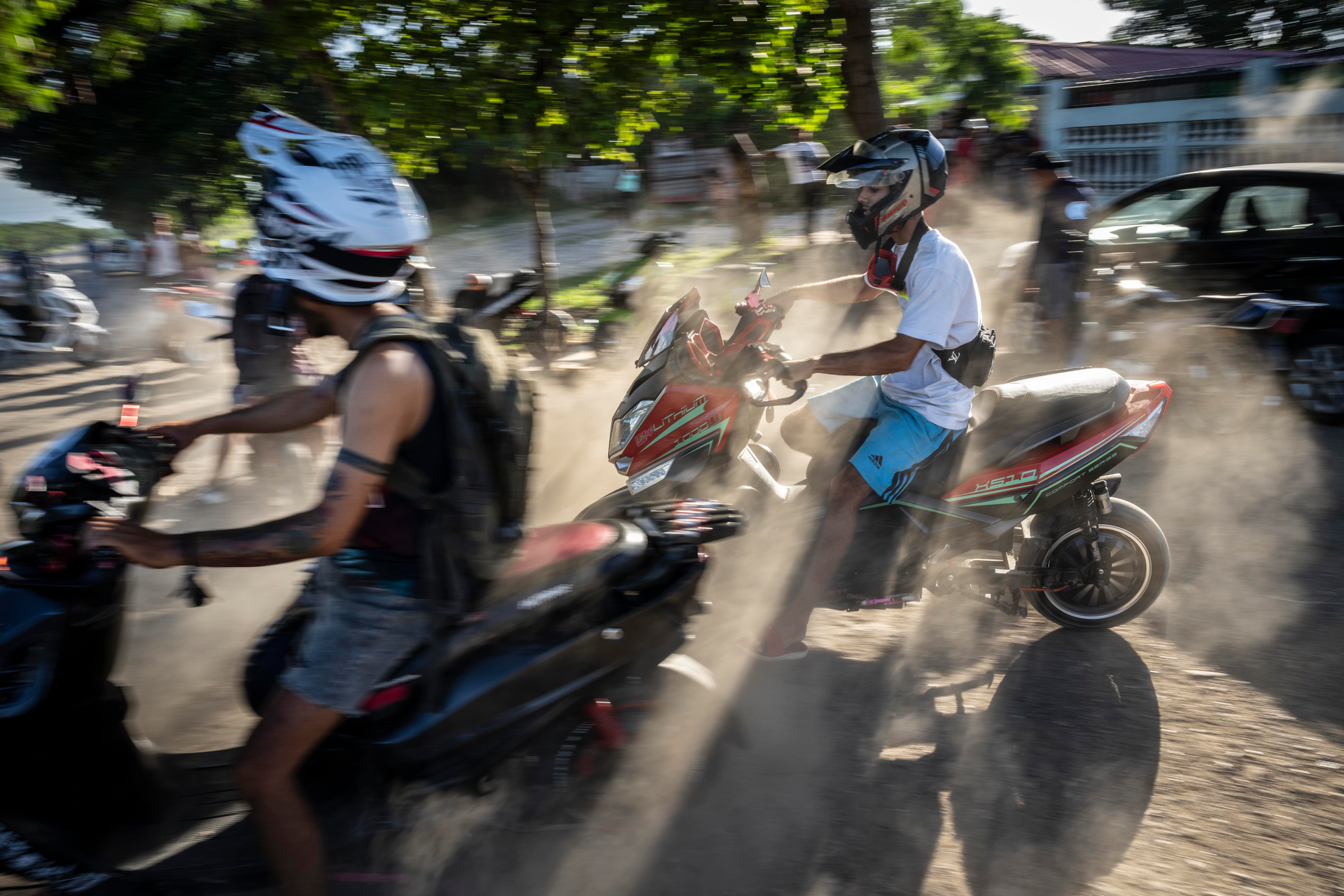 People gather on their electric scooters to spend the late afternoon showing off stunts and racing in Havana, Cuba, Friday, July 15, 2022.