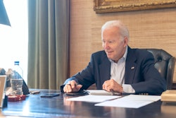 In this image provided by the White House, President Joe Biden speaks with Sen. Bob Casey, D-Pa., on the phone from the Treaty Room in the residence of the White House Thursday, July 21, 2022, in Washington. Biden says he's 'doing great' after testing positive for COVID-19. The White House said Biden is experiencing 'very mild symptoms,' including a stuffy nose, fatigue and cough. He's taking Paxlovid, an antiviral drug designed to reduce the severity of the disease.