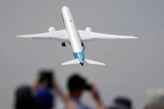 A Boing 777X plane takes off at the Farnborough Air Show fair in Farnborough, England, Monday, July 18, 2022. Some 1200 exhibitors from around the world will show their newest developments in Future Flight, Space, Defence, Innovation, Sustainability and Workforce from July 18 until July 22, 2022.