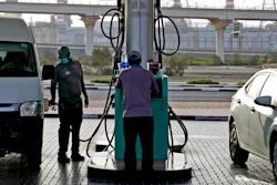 A gas station attendant fills a gas tank in Dubai, United Arab Emirates, Sunday, July 10, 2022. Mere years ago, fuel was cheaper than bottled water in the oil-rich United Arab Emirates. Now, long lines snake outside gas stations on the eve of monthly price hikes.