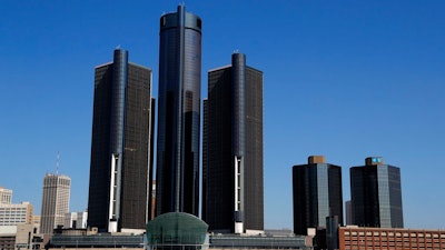 This May 12, 2020, file photo, shows a general view of the Renaissance Center, headquarters for General Motors, along the Detroit skyline from the Detroit River. General Motors will keep its headquarters in its seven-building office tower complex in downtown Detroit, its CEO says. Mary Barra, in an interview with The Associated Press, says the automaker’s main office will remain in the Renaissance Center, the centerpiece of the city’s skyline just across the Detroit River from Canada.