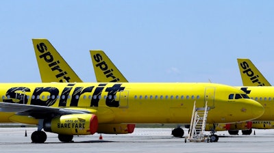 A line of Spirit Airlines jets sit on the tarmac at the Orlando International Airport on May 20, 2020, in Orlando, Fla. Spirit announced on Thursday, July 7, 2022, that it would again postpone a vote on the proposed merger with Frontier, a sign that it lacks shareholder support for the merger in the face of a rival bid by JetBlue Airways. Spirit delayed the vote by a week, until July 15.