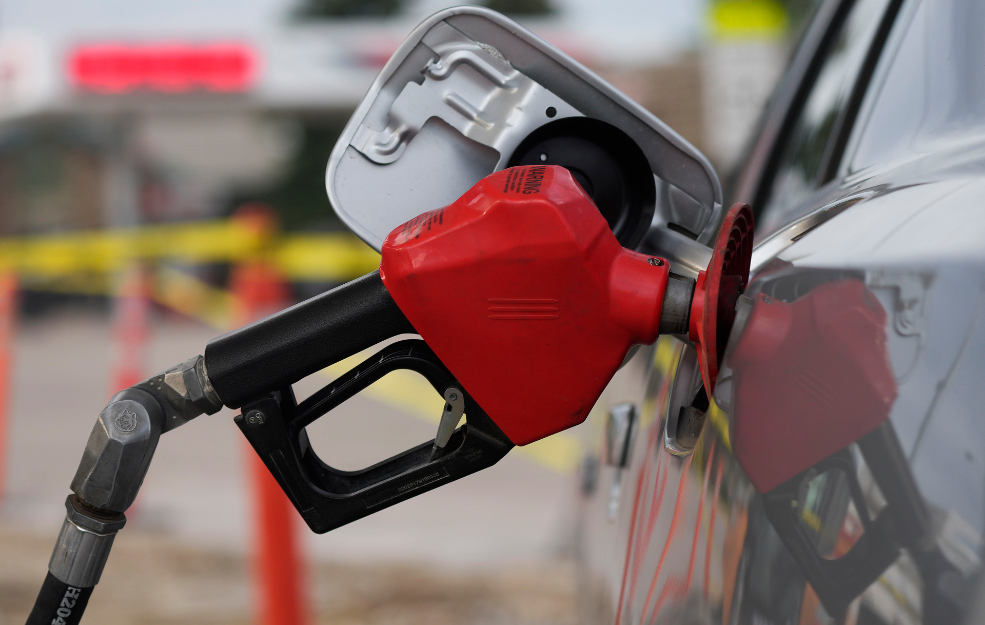 A motorist fills up the tank on a sedan, Saratoga, Wyo., July 22, 2022.
