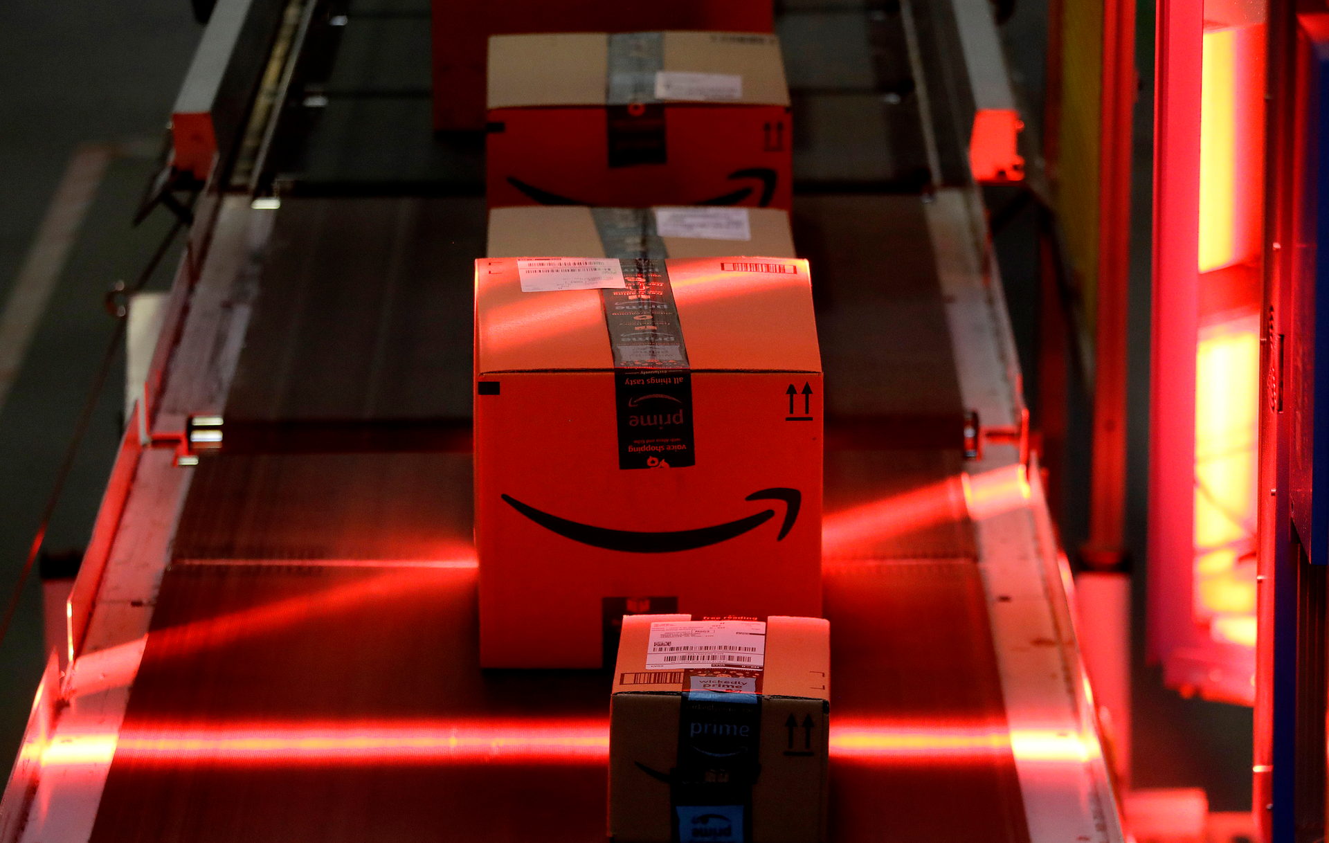 Packages riding on a belt are scanned to be loaded onto delivery trucks at the Amazon Fulfillment center in Robbinsville Township, N.J., on Aug. 1, 2017.