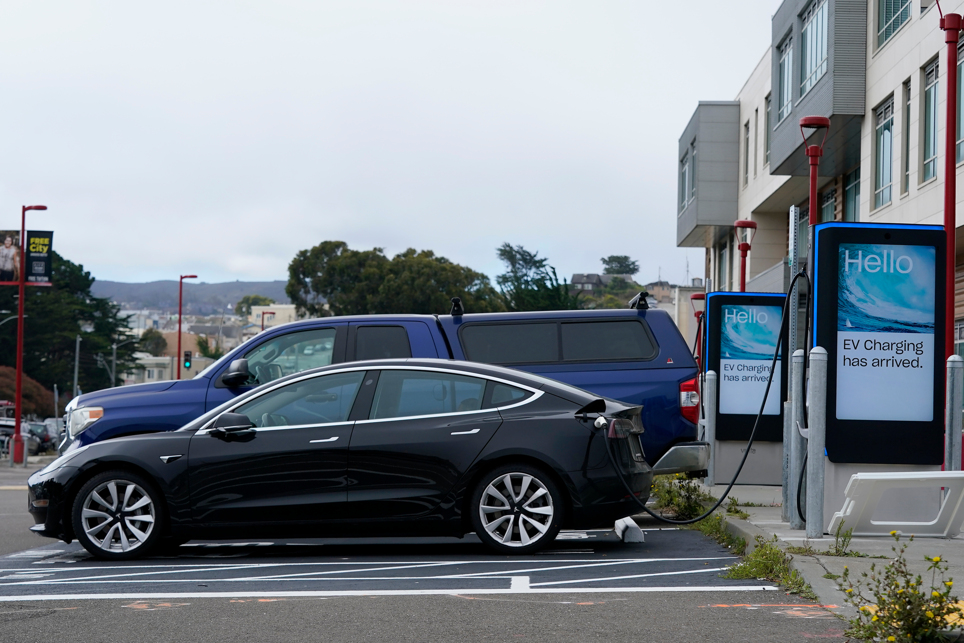 Cars are parked at an electric charging station in San Francisco, Thursday, Aug. 25, 2022. California is poised to required 100% of new cars, trucks and SUVs sold in the state to be powered by electricity or hydrogen by 2035.