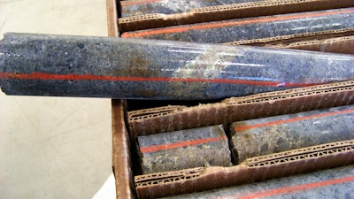 In this Oct. 4, 2011, file photo, a core sample drilled from underground rock near Ely, Minn., shows a band of shiny minerals containing copper, nickel and precious metals, center, that Twin Metals Minnesota LLC, hopes to mine near the Boundary Waters Canoe Area Wilderness in northeastern Minnesota. On Monday, Aug. 22, 2022, Twin Metals sued the Biden administration to seek the reinstatement of federal mineral rights leases that are crucial to the $1.7 billion project.