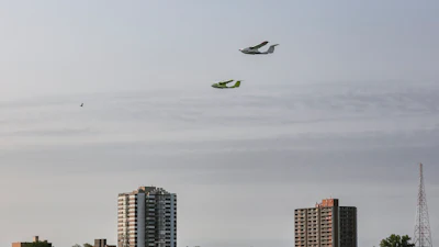 This photo provided by ICON Aircraft shows two ICON A5s, two-seat, amphibious, light-sport aircraft, flying above the Detroit River in Detroit on Thursday, Sept. 15, 2022. ICON Aircraft is one of the companies displaying their flying vehicles at the North American International Auto Show as part of the event's Air Mobility Experience segment.