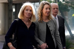 Former Theranos CEO Elizabeth Holmes, center, her mother, Noel Holmes, left, and father, Christian Holmes IV, arrive at federal court in San Jose, Calif., Thursday, Sept. 1, 2022.