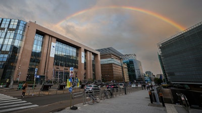 A rainbow forms between the European Council building, left, and the European Commission building right outside a meeting of EU energy ministers in Brussels, Friday, Sept. 9, 2022.