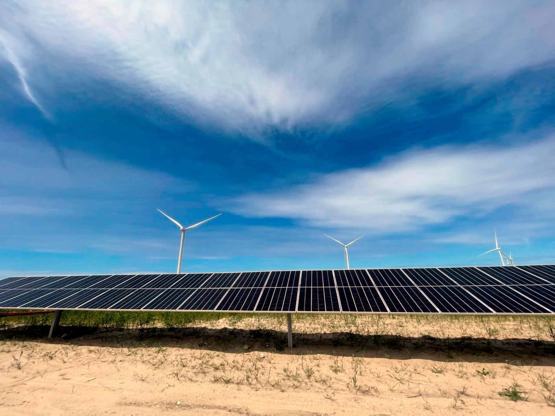 In this image provided by Portland General Electric, windmills and solar panels line a renewable energy facility in Lexington, Ore., on this May 24, 2022.