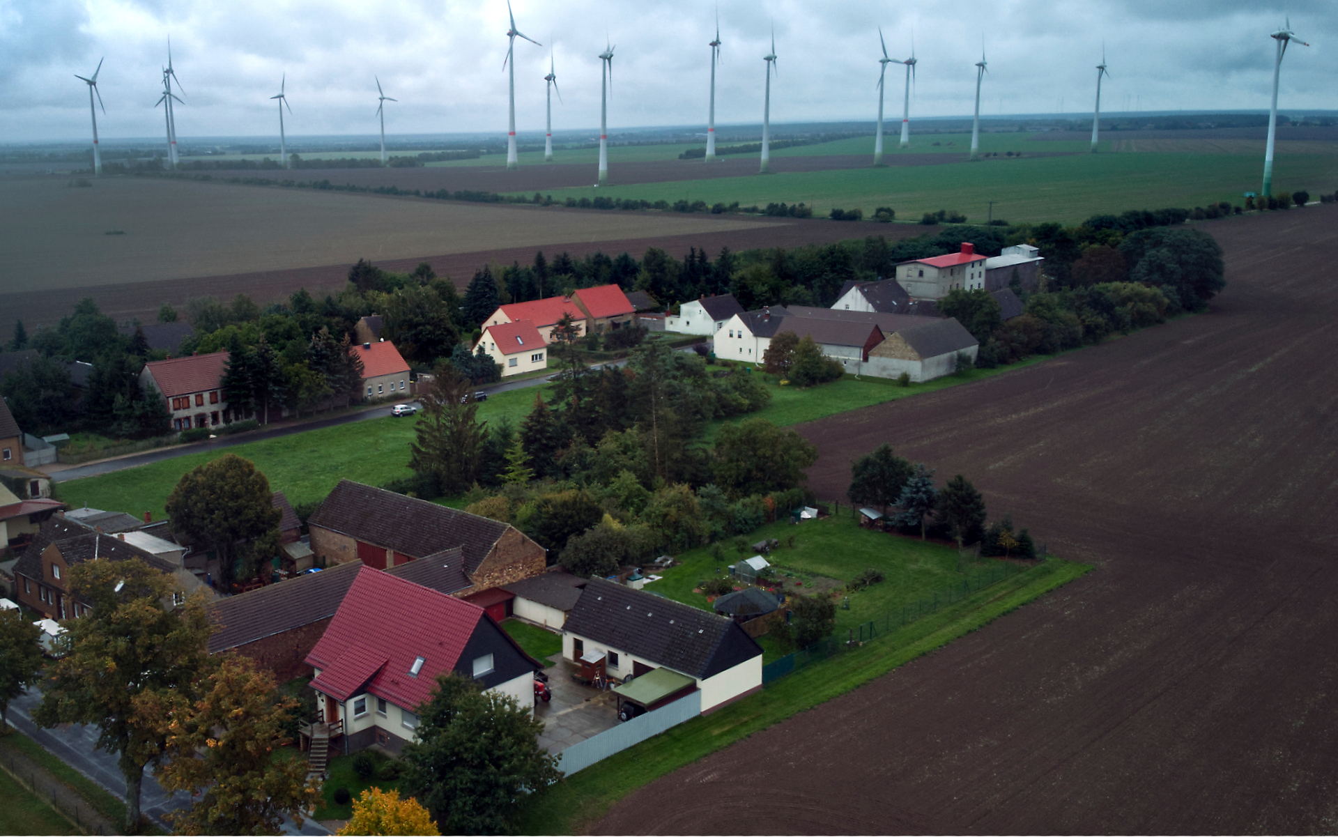 Wind turbines turn near the village of Feldheim, rear left, near Treuenbrietzen, Germany, Wednesday, Sept. 28, 2022.