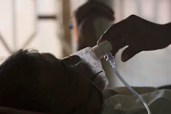 A relative adjusts the oxygen mask of a tuberculosis patient at a TB hospital on World Tuberculosis Day in Hyderabad, India, March 24, 2018.