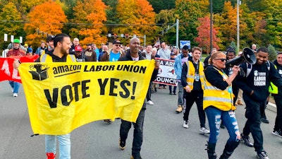 Amazon workers and supporters march during a rally in Castleton-On-Hudson, about 15 miles south of Albany, N.Y., Monday, Oct. 10, 2022. The startup union that clinched a historic labor victory at Amazon earlier this year is slated to face the company yet again, aiming to rack up more wins that could force the reluctant retail behemoth to the negotiating table.
