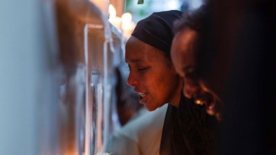 Ethiopian relatives of some of the crash victims light candles and gather at an anniversary memorial service at the Holy Trinity Cathedral in Addis Ababa, Ethiopia, March 8, 2020, to remember those who died when Ethiopian Airlines flight ET302, a Boeing 737 Max, crashed shortly after takeoff on March 10, 2019, killing all 157 on board. A federal judge ruled Friday, Oct. 21, 2022, that relatives of people who were killed in the crashes of two Boeing 737 Max planes are crime victims under federal law, finding that the Justice Department should have notified families before privately negotiating a settlement that spared Boeing from criminal prosecution.