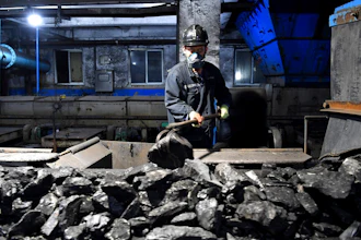 In this photo released by Xinhua News Agency, a worker sort coals at Qianyingzi coal mine in Suzhou, east China's Anhui Province, Oct. 20, 2021. China plans to boost coal production through 2025 to avoid a repeat of last year's power shortages, an official said Monday, Oct. 17, 2022. adding to setbacks in efforts to cut climate-changing carbon emissions from the biggest global source.