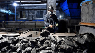 In this photo released by Xinhua News Agency, a worker sort coals at Qianyingzi coal mine in Suzhou, east China's Anhui Province, Oct. 20, 2021. China plans to boost coal production through 2025 to avoid a repeat of last year's power shortages, an official said Monday, Oct. 17, 2022. adding to setbacks in efforts to cut climate-changing carbon emissions from the biggest global source.