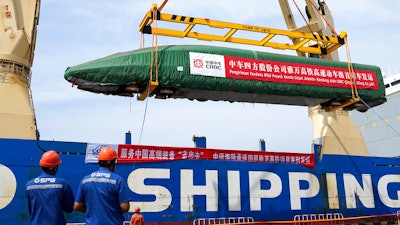 In this photo released by Xinhua News Agency, a high-speed electric passenger train, customized for the Jakarta-Bandung High-Speed Railway (HSR) project, is loaded onto a vessel in Qingdao Port in eastern China's Shandong Province, Aug. 18, 2022. China reported Monday, Oct. 24, 2022 economic growth rises to 3.9% over a year ago in latest quarter, up from 0.4% in previous quarter.