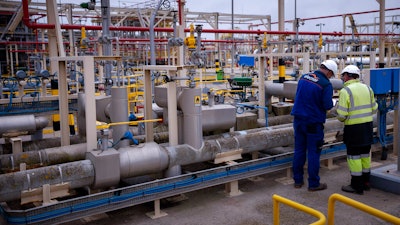 Operators work at Enagas regasification plant, the largest LNG plant in Europe, in Barcelona, Spain, March 29, 2022. Households and businesses across Europe have been suffering for months from soaring electricity prices, but Iberian countries Spain and Portugal have managed to free themselves from the EU pricing system and Spain says the benefits are noticeable.