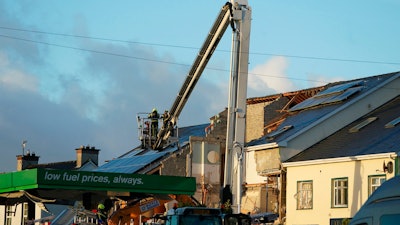 Emergency services work at the scene of an explosion at Applegreen service station in the village of Creeslough in Co Donegal, Ireland, Saturday, Oct. 8, 2022.