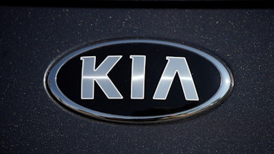 The company logo shines off the hood of a 2021 K5 sedan on display in the Kia exhibit at the Denver auto show Friday, Sept. 17, 2021, at Elitch's Gardens in downtown Denver.