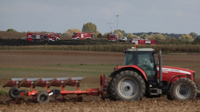 Firefighters work to pump out oil in the area of a leak from a pipeline that carries crude oil from Russia to Germany near the village of Zurawice, Poland, Wednesday, Oct. 12, 2022.