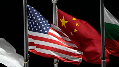 The American and Chinese flags wave at Genting Snow Park ahead of the 2022 Winter Olympics on Feb. 2, 2022, in Zhangjiakou, China.