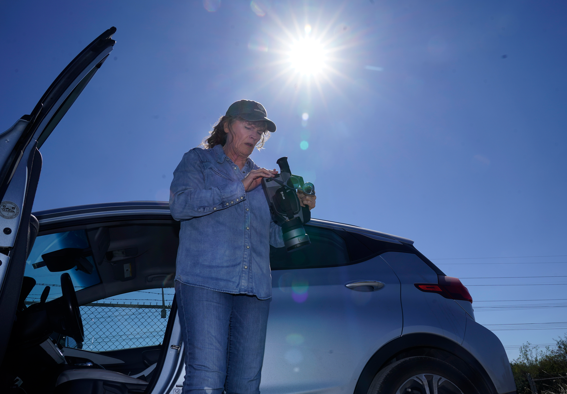 Sharon Wilson sets up a thermal imaging camera near a compressor station in Arlington, Texas, Tuesday, Oct. 18, 2022.