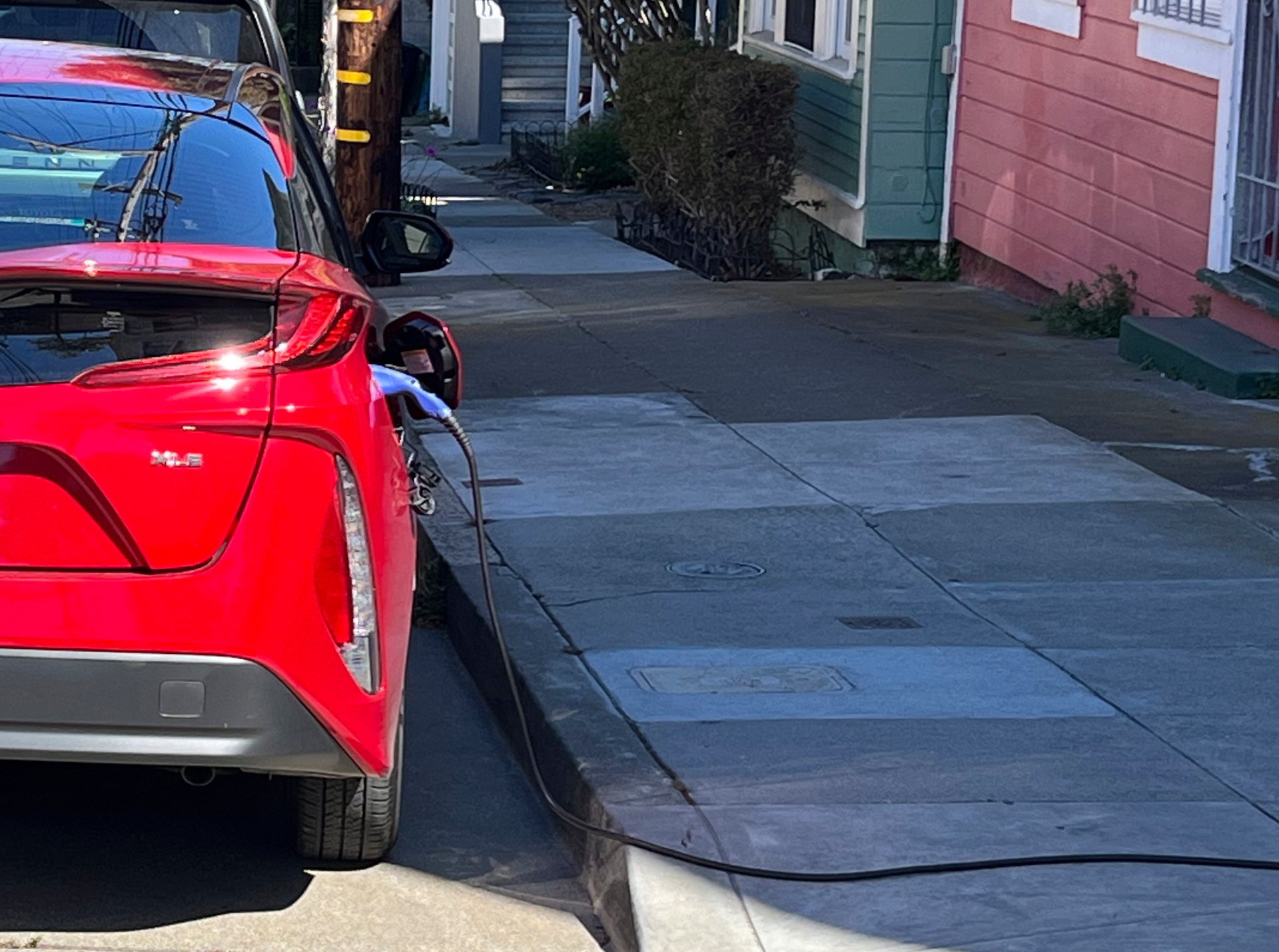 A charging cord for an electric vehicle is seen strung across a public sidewalk in San Francisco on Sept. 23, 2022.